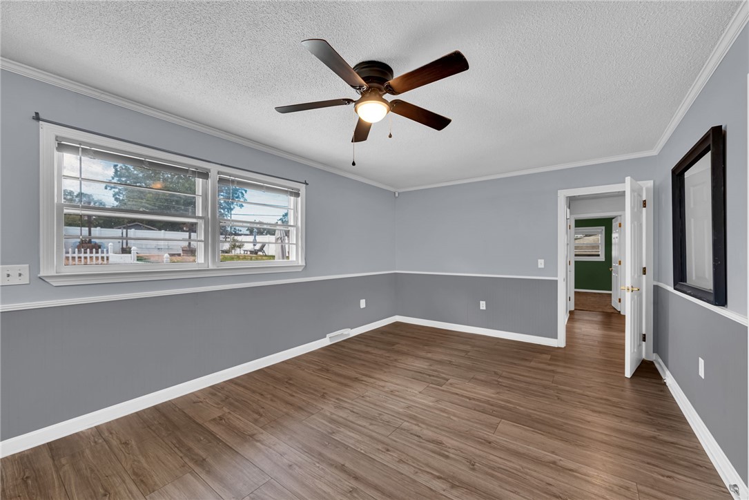 121 Wilson Road Anderson, SC 29625 - Photo 8 of 40 Rich wood-look flooring and crisp crown molding define this versatile living area.