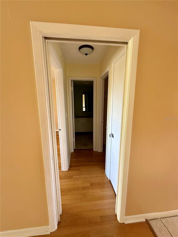 6306 Newtown Circle, Unit 6C5 Tampa, FL 33615 - Photo 15 of 24 a view of a hallway with wooden floor