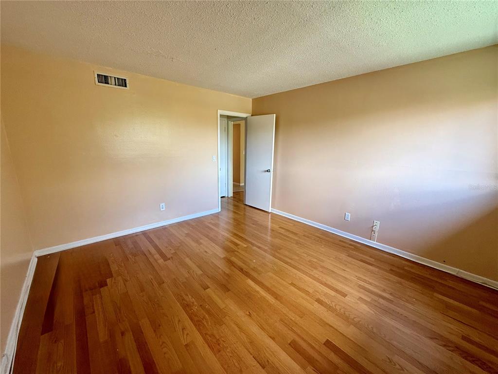 6306 Newtown Circle, Unit 6C5 Tampa, FL 33615 - Photo 17 of 24 a view of an empty room and wooden floor