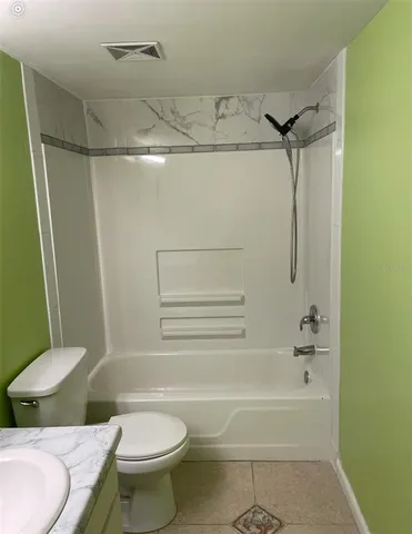 a bathroom with a toilet and a bathtub