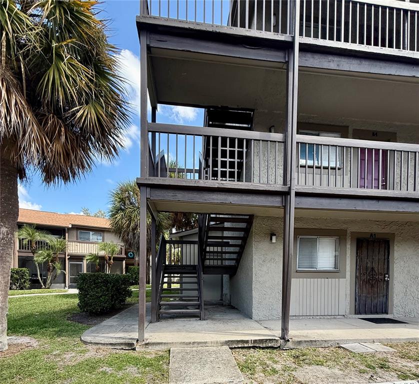 6306 Newtown Circle, Unit 6C5 Tampa, FL 33615 - Photo 2 of 24 a front view of a house with a yard