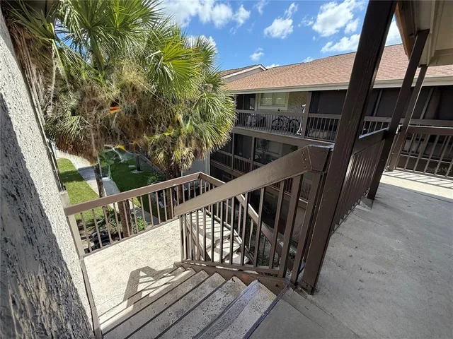 a view of balcony with wooden floor and fence