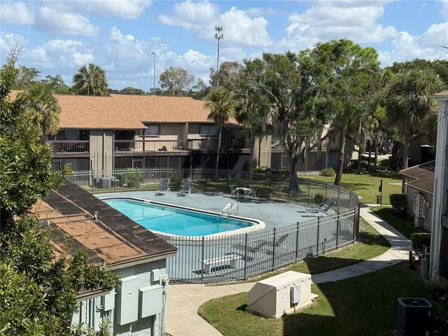 a view of a house with pool and sitting area
