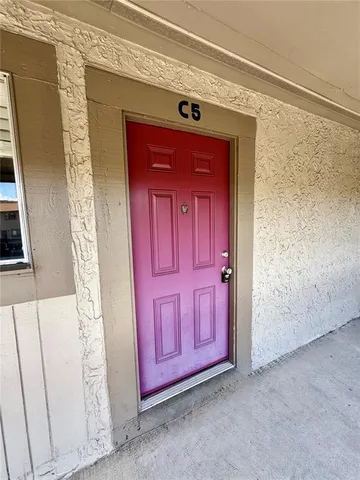 a view of front door with a red door