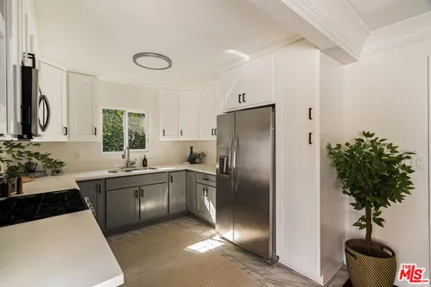 a bedroom with a bed and a potted plant