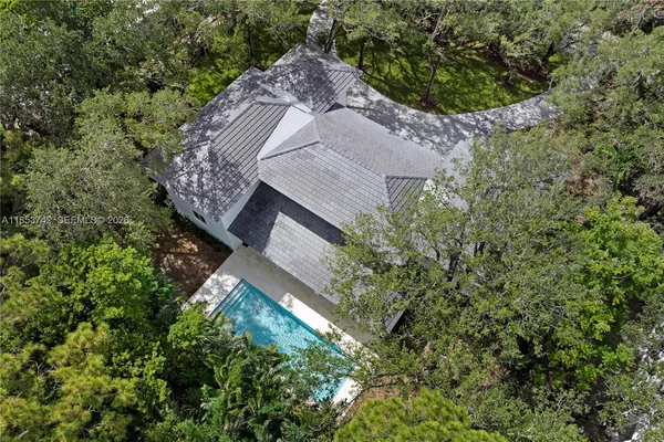 an aerial view of a house with a yard and plants