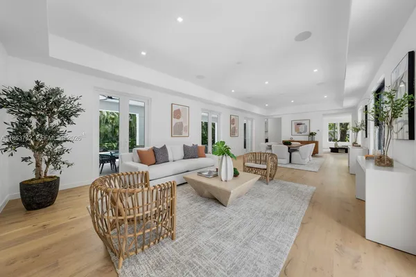 a living room with furniture potted plant and a table