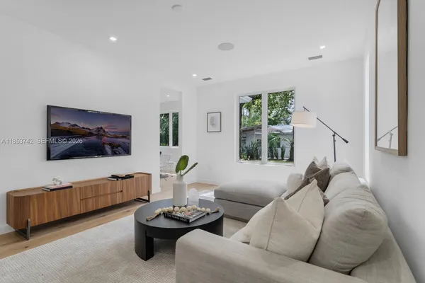 a living room with furniture and a flat screen tv