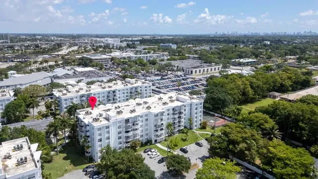 an aerial view of residential building with green space
