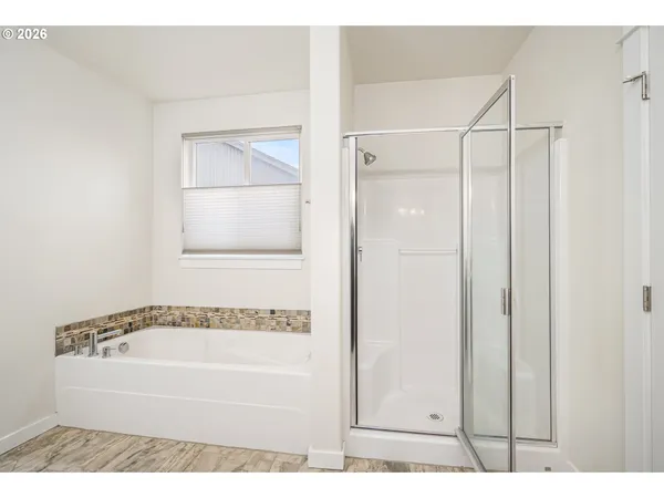 a bathroom with a bathtub and a shower