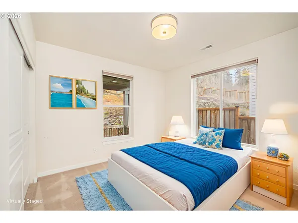 a bedroom with a bed and a large window