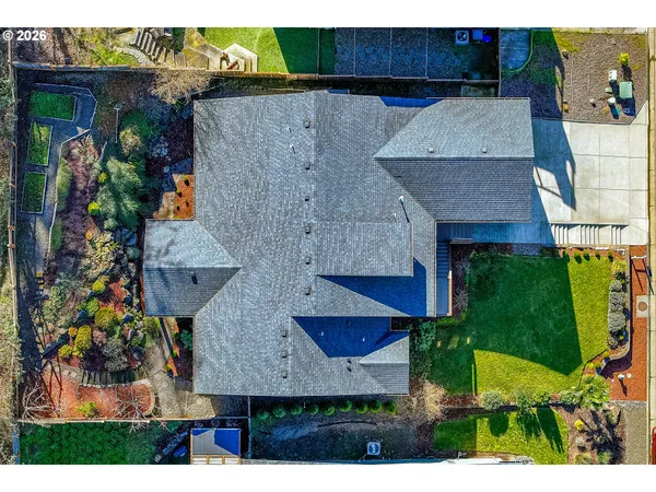 an aerial view of a house with a yard and fountain