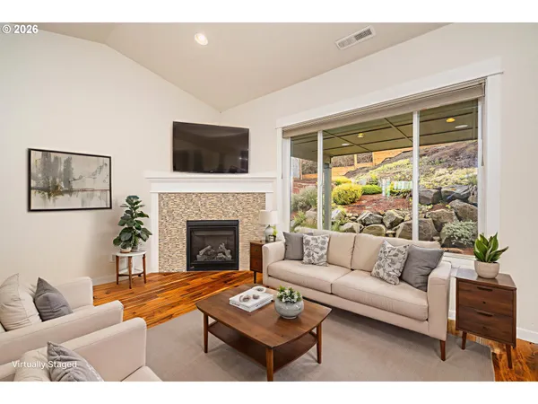 a living room with furniture a flat screen tv and a fireplace