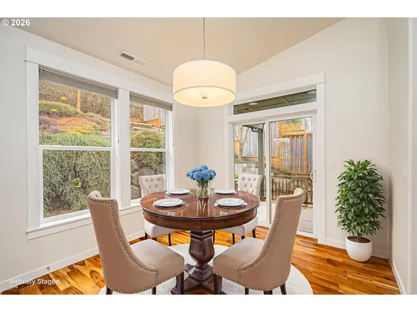 a dining room with furniture wooden floor and a chandelier