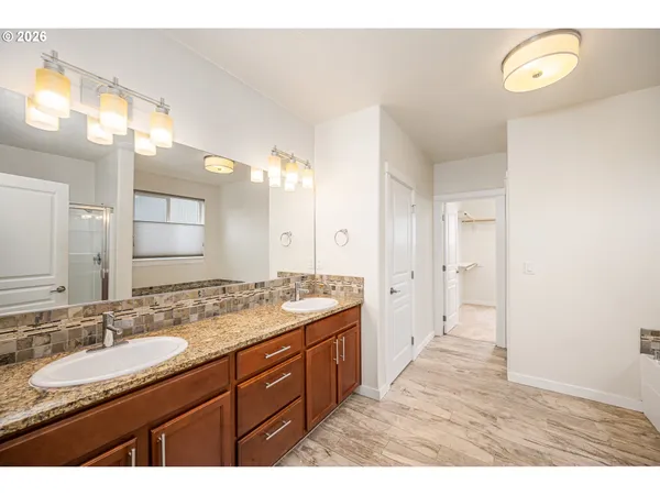 a bathroom with a granite countertop sink mirror and double