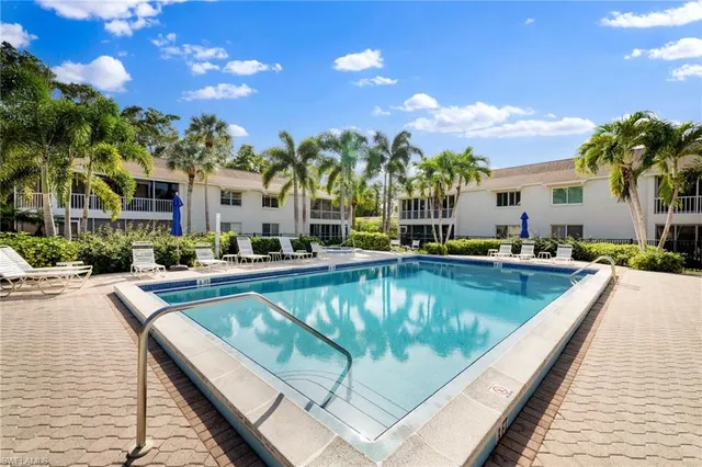 a view of swimming pool with outdoor seating and a potted plants