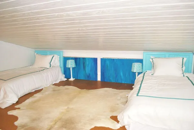 a bedroom with a bed and a night stand