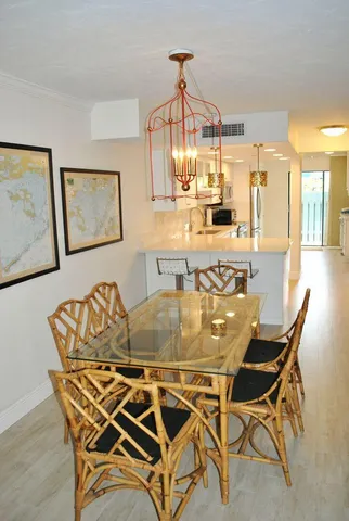 a dining room with furniture and view kitchen
