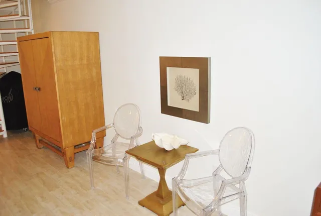 a living room with a table and a chair