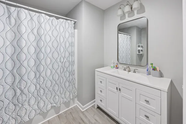 a bathroom with a double vanity sink and mirror