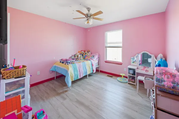 a bedroom with furniture and a wooden floor