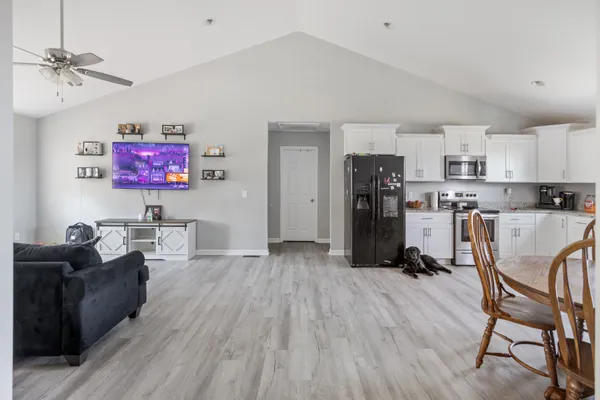 a living room with furniture and a wooden floor