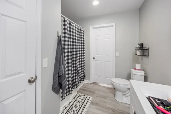 a bathroom with a sink toilet and shower