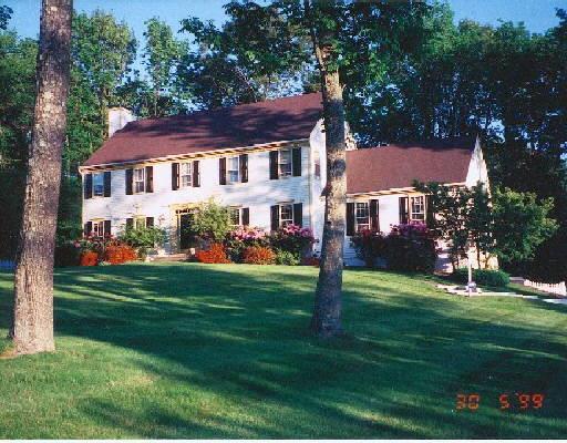 15 Berthier Place Ridgefield, CT 06877 - Photo 1 of 1 a front view of a house with a garden and trees