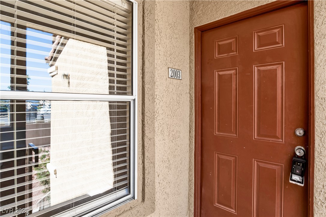 2300 East Silverado Ranch Boulevard, Unit 2003 Las Vegas, NV 89123 - Photo 1 of 19 Property entrance with stucco siding