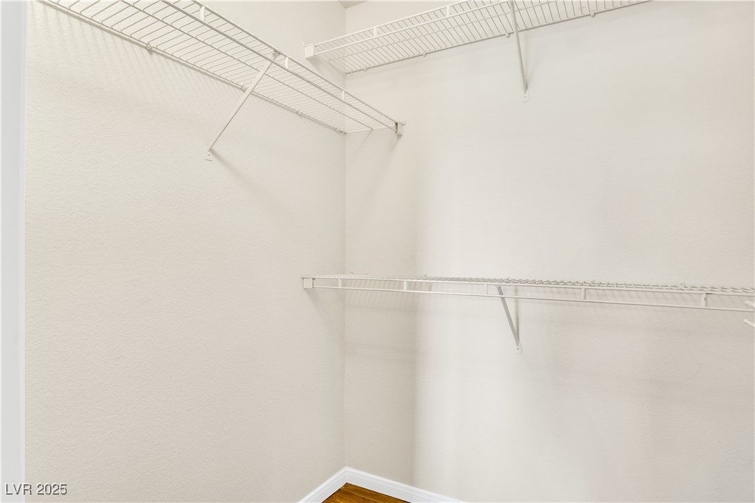 2300 East Silverado Ranch Boulevard, Unit 2003 Las Vegas, NV 89123 - Photo 15 of 19 Walk in closet featuring wood finished floors