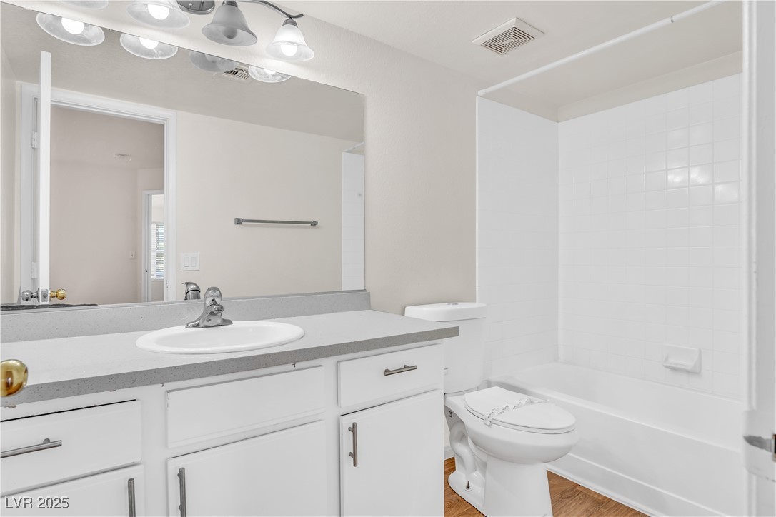 2300 East Silverado Ranch Boulevard, Unit 2003 Las Vegas, NV 89123 - Photo 16 of 19 Full bathroom with vanity, light wood-style floors, and shower / bath combination