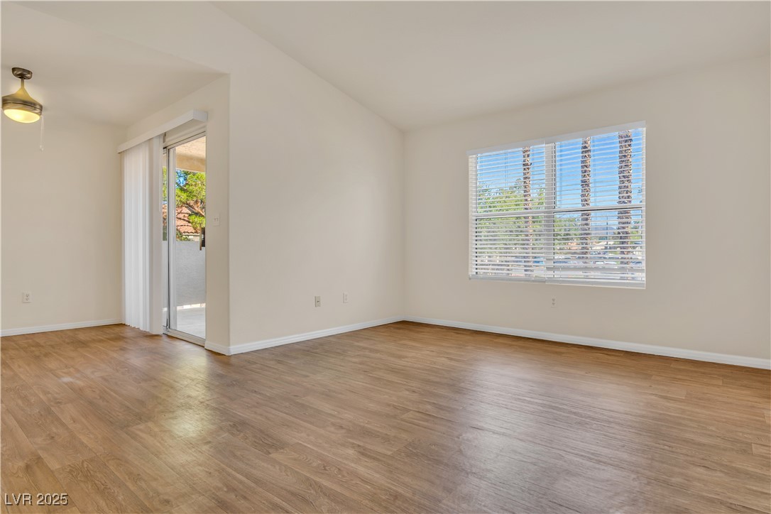 2300 East Silverado Ranch Boulevard, Unit 2003 Las Vegas, NV 89123 - Photo 2 of 19 Empty room with light wood-style flooring and healthy amount of natural light