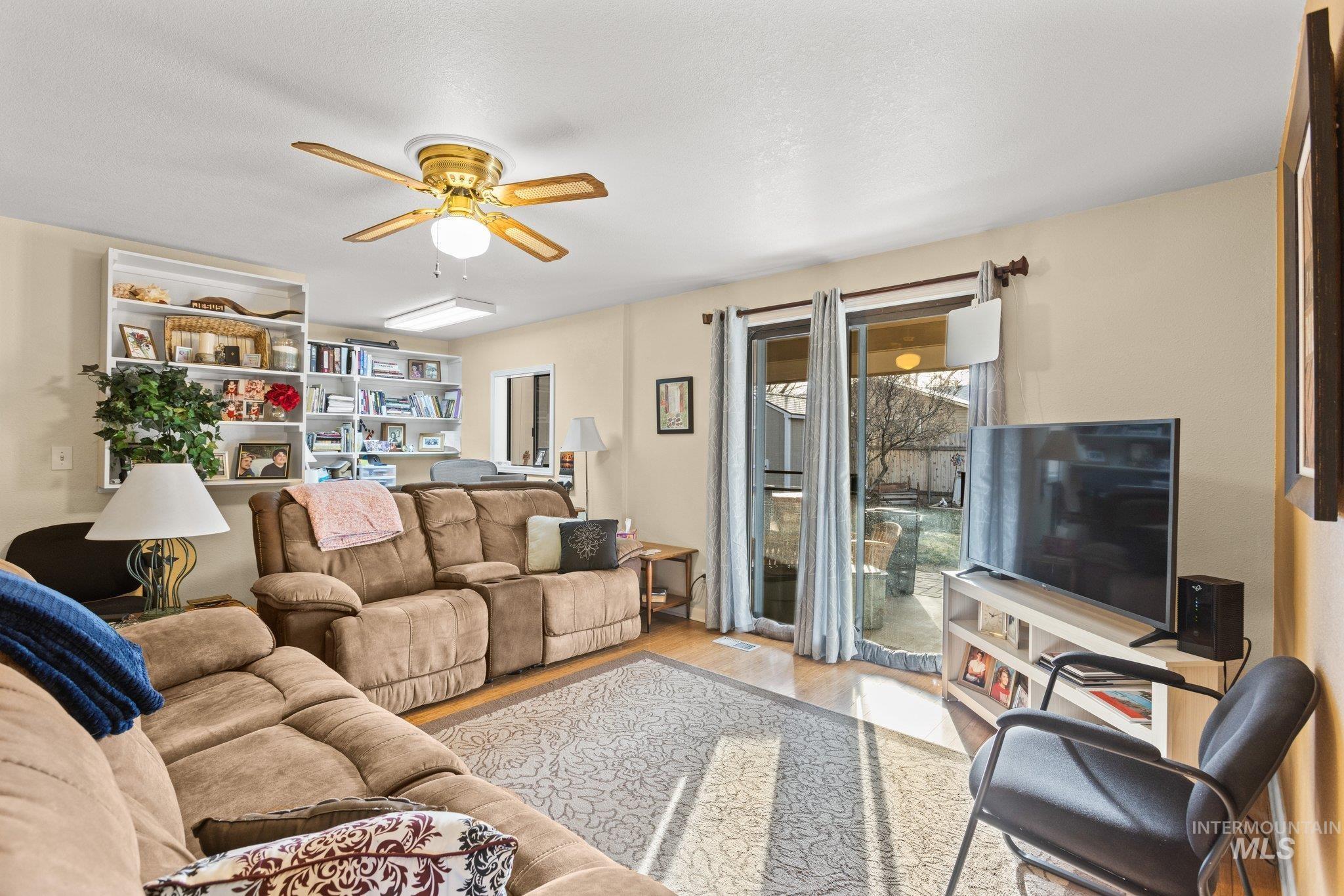 7567 Sundance Drive Boise, ID 83709 - Photo 18 of 21 Living room featuring wood finished floors and ceiling fan