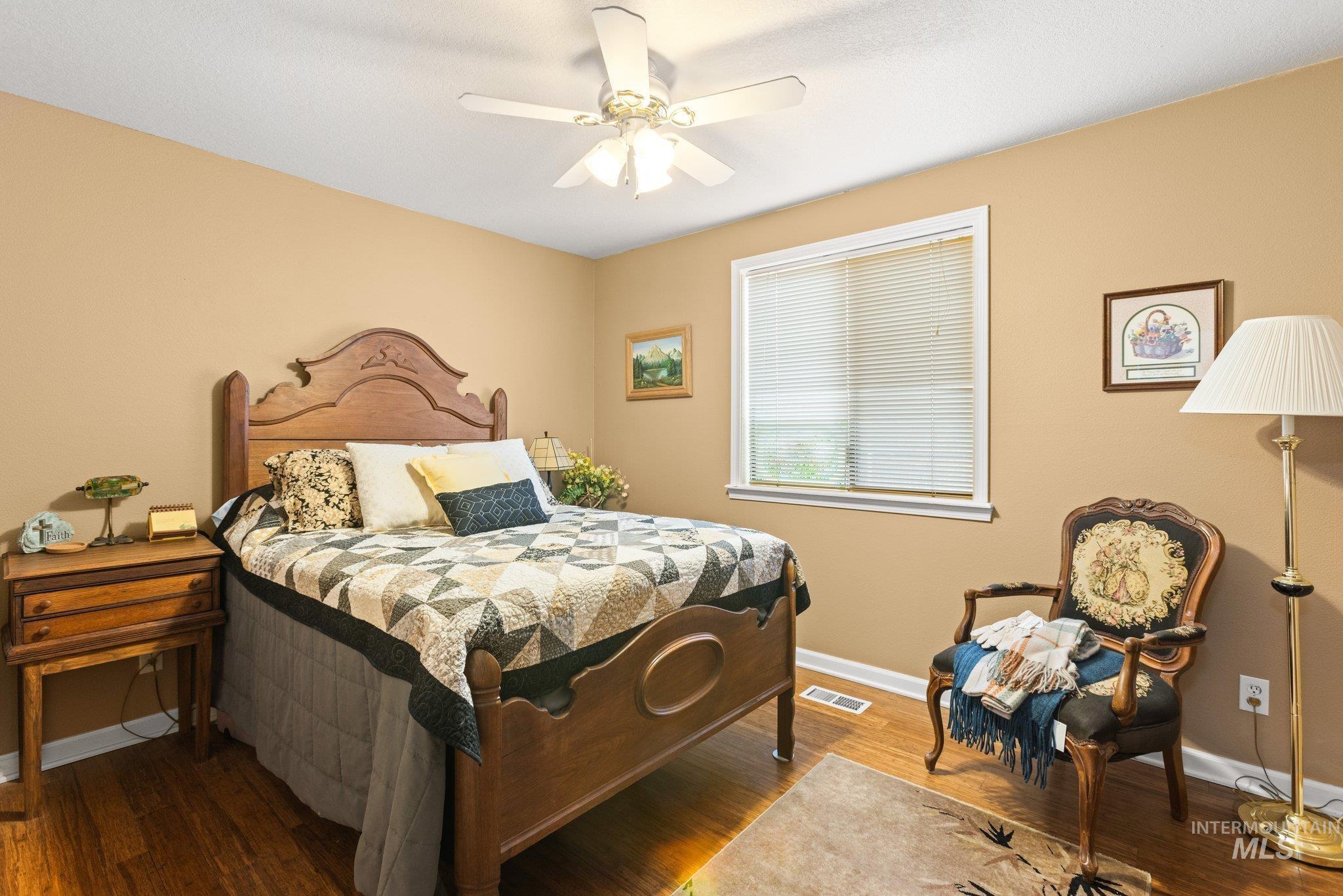 7567 Sundance Drive Boise, ID 83709 - Photo 9 of 21 Bedroom featuring wood finished floors and ceiling fan