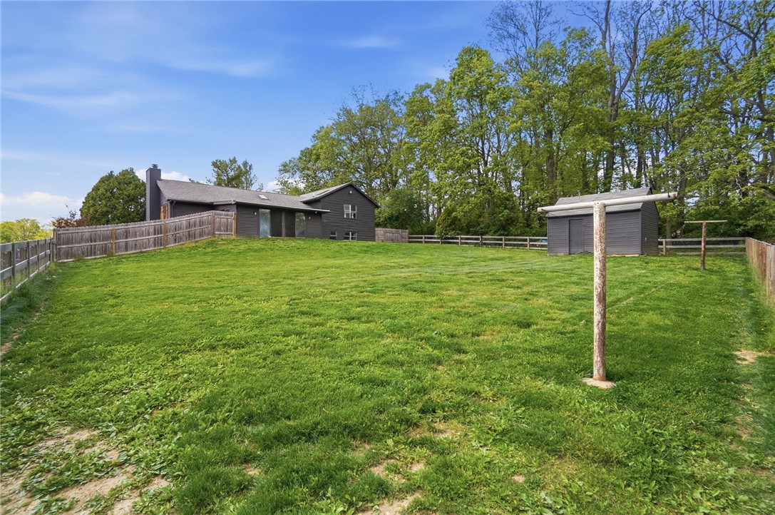 5209 North Addison New Carlisle Road St. Paris, OH 43072 - Photo 46 of 47 Expansive green yard with a private fence, offering a serene outdoor retreat.