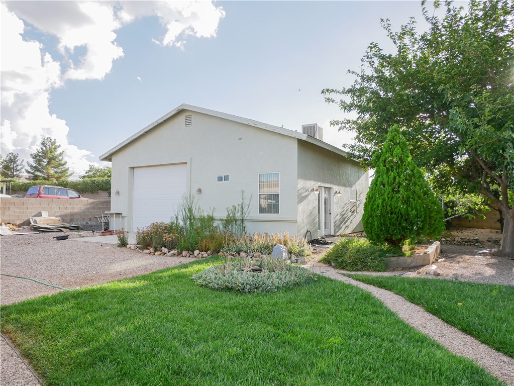 2575 Triangle S Street Kingman, AZ 86401 - Photo 38 of 45 a view of a house with a yard and table and chairs under an umbrella