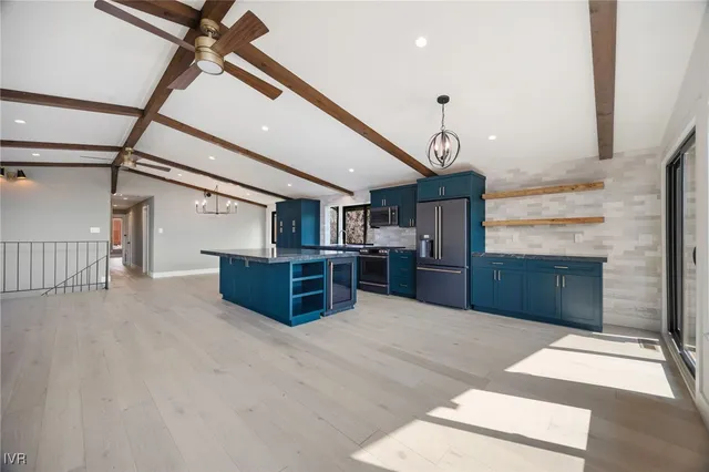 a kitchen with stainless steel appliances granite countertop a sink a stove and a refrigerator