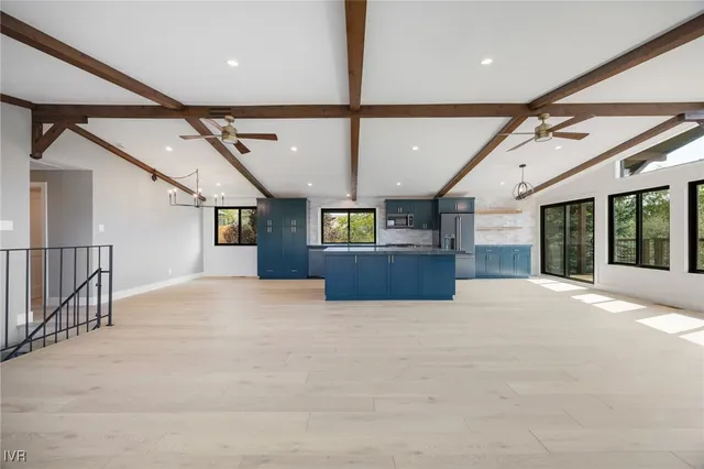 a view of kitchen with refrigerator and window