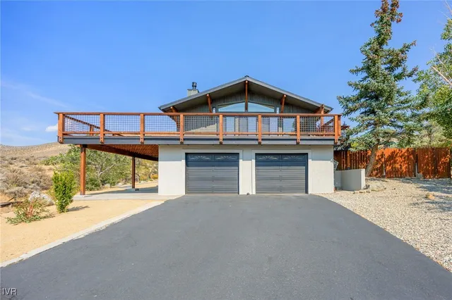 an aerial view of house with yard and mountain view in back