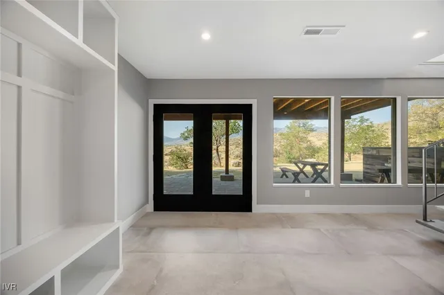 an empty room with windows and closet