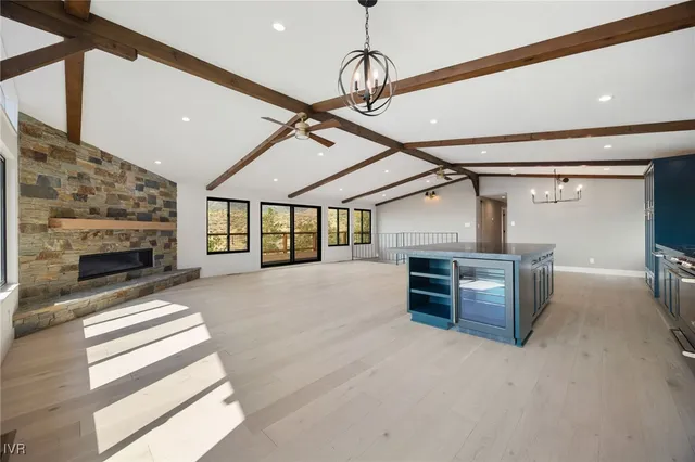 a kitchen with stainless steel appliances kitchen island granite countertop a refrigerator and microwave