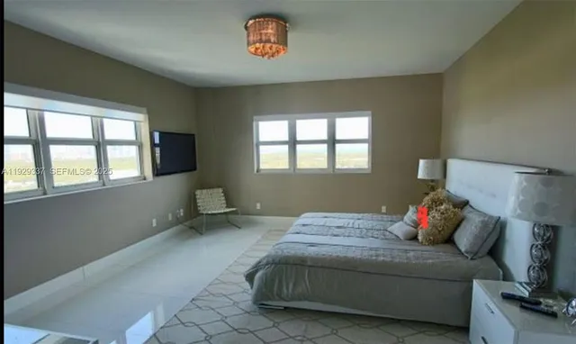 a bedroom with a large bed and a dresser