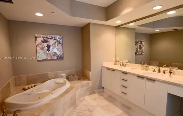 a bathroom with a granite countertop sink a toilet and a mirror