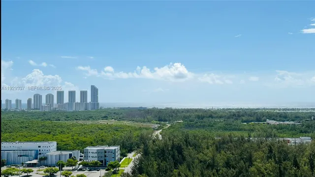 a view of a city with lush green space
