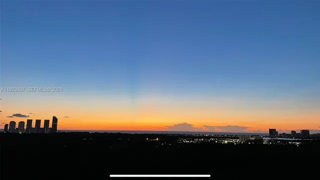 a view of a dining room with furniture large windows and wooden floor
