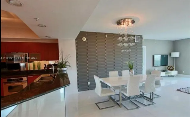 a kitchen with stainless steel appliances granite countertop a sink a stove and a refrigerator