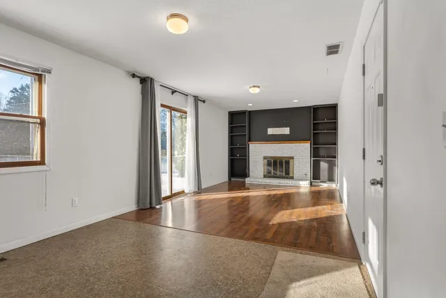 an empty room with windows and entrance