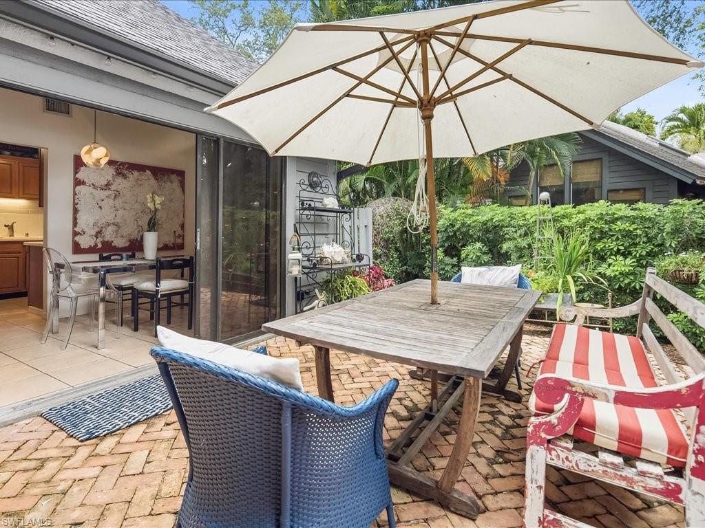 1337 Solana Road Naples, FL 34103 - Photo 11 of 23 Brick paver patio featuring lush perimeter landscaping