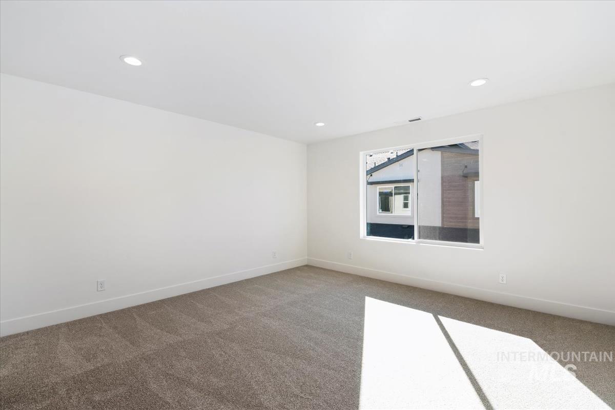 752 South Calhoun Lane Star, ID 83669 - Photo 29 of 45 Bright room featuring recessed lighting, a large window, neutral carpeting, white walls, and white baseboards