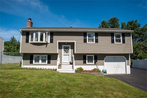 227 West Meadow Road Lowell, MA 01854 - Photo 1 of 25 a front view of a house with a yard